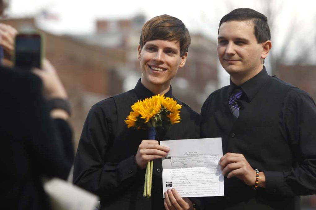 A same-sex couple show off their marriage licence after they tied the knot in Montgomery, Alabama. Photo: AP Photo
