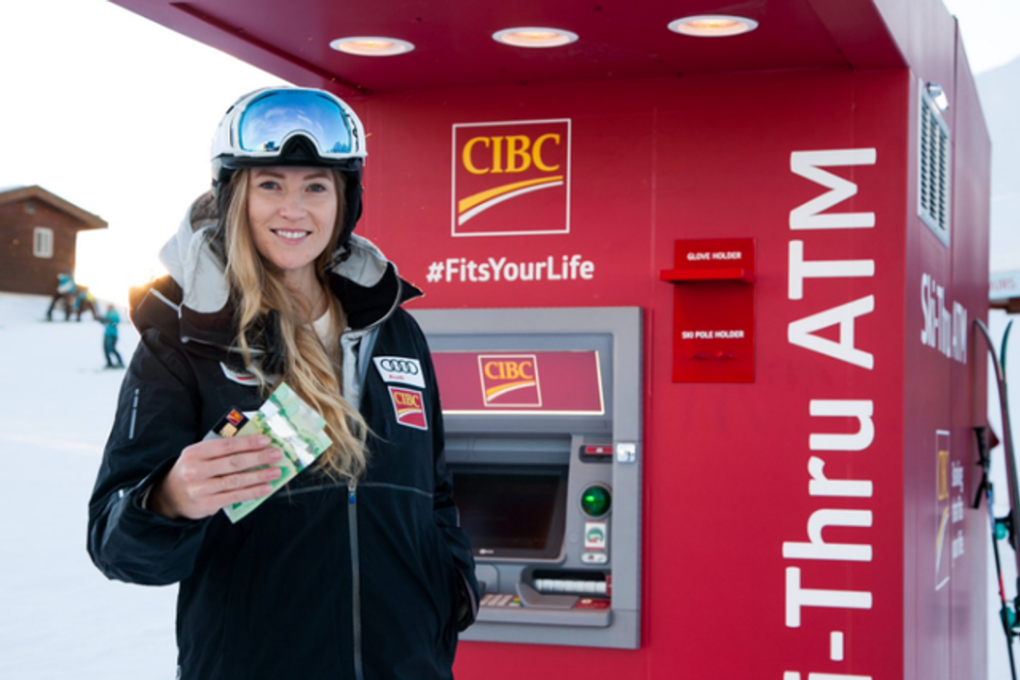 Ashleigh DeMerit uses the new CIBC ATM atop Whistler Mountain. DeMerit won a gold medal at the 2010 Winter Olympics in ski cross when she was known as Ashleigh McIvor. She has since married former Vancouver Whitecap Jay DeMerit. Photo: CIBC