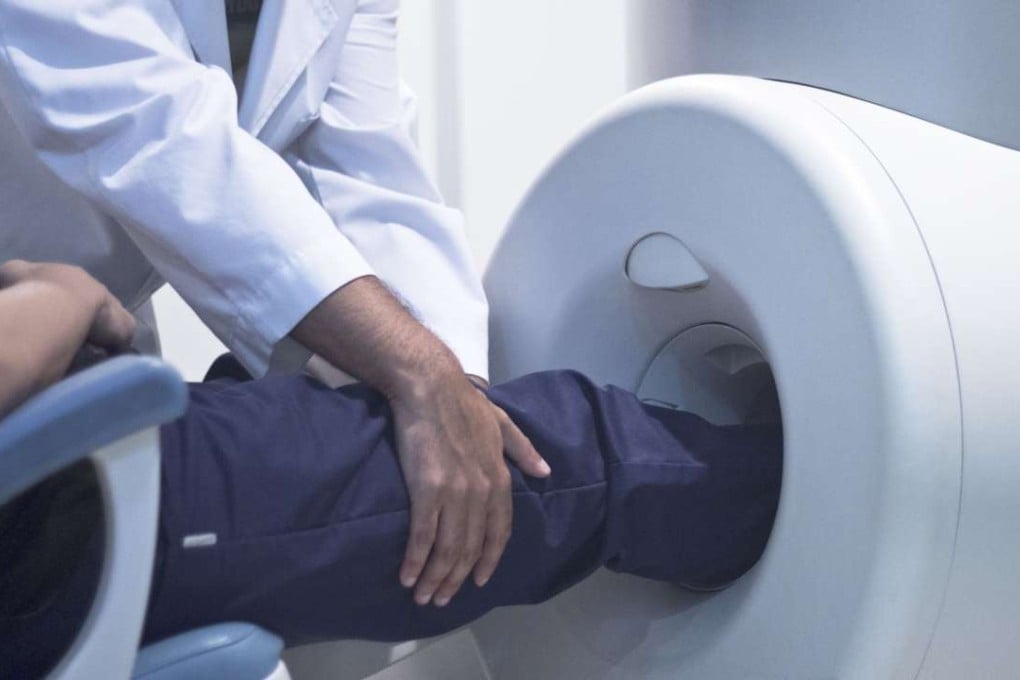 A patient is prepared for a knee MRI.