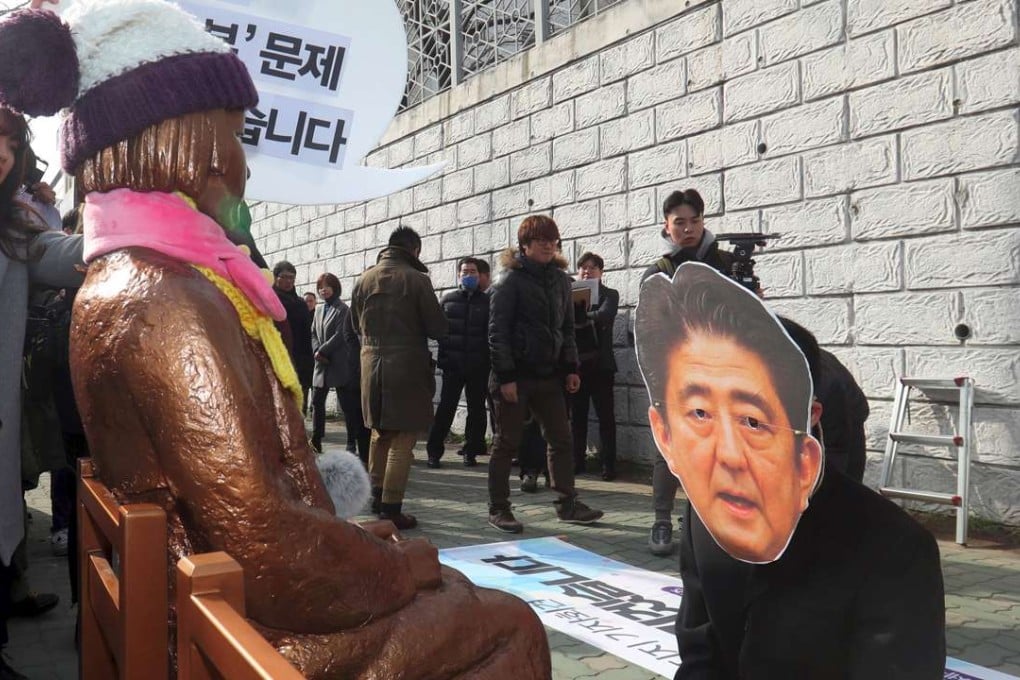 A South Korean protester wearing a mask of Japanese Prime Minister Shinzo Abe kneels in mock apology in front of the ‘comfort women’ statue outside the Japanese consulate in Busan. The statue symbolises the women who served as sex slaves for Japanese soldiers during the second world war. Photo: AFP