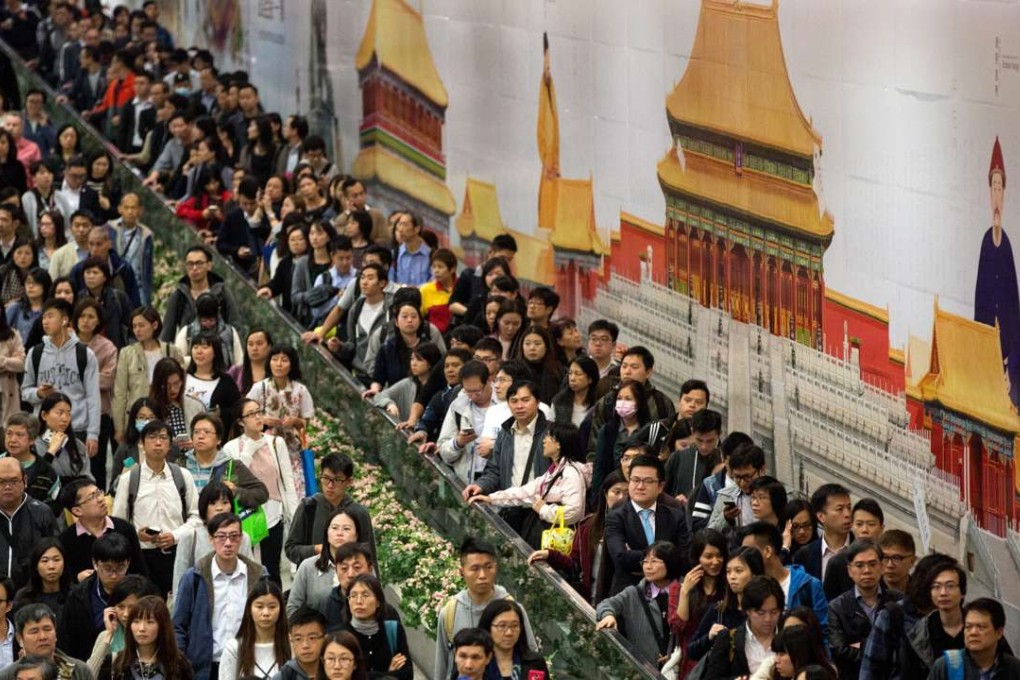 Commuters on the walkway between the Central and Hong Kong MTR stations pass giant posters advertising the local Palace Museum project, on January 10. The posters, part of a HK$1.58 million “exhibition”, sparked a demonstration the previous day by pro-democracy protesters who said they were reminiscent of the June 1989 crackdown on students at Tiananmen Square. Photo: EPA