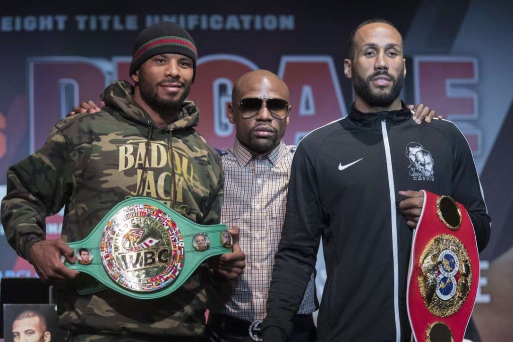 Floyd Mayweather Jnr stands with IBF super middleweight champion James DeGale and WBC super middleweight champion Badou Jack ahead of their Saturday night bout in New York. Photo: AP