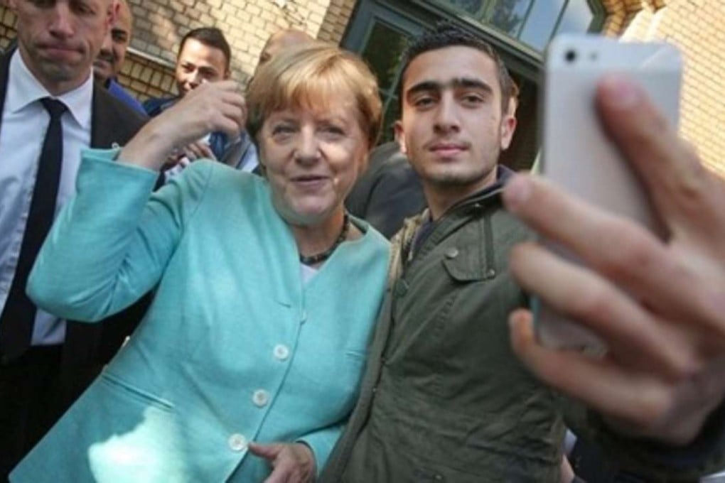 Syrian refugee Anas Modamani snaps a selfie with German Chancellor Angela Merkel in 2015. The image was seized upon by people who incorrectly claimed that Modamani was a terrorist. Photo: Twitter