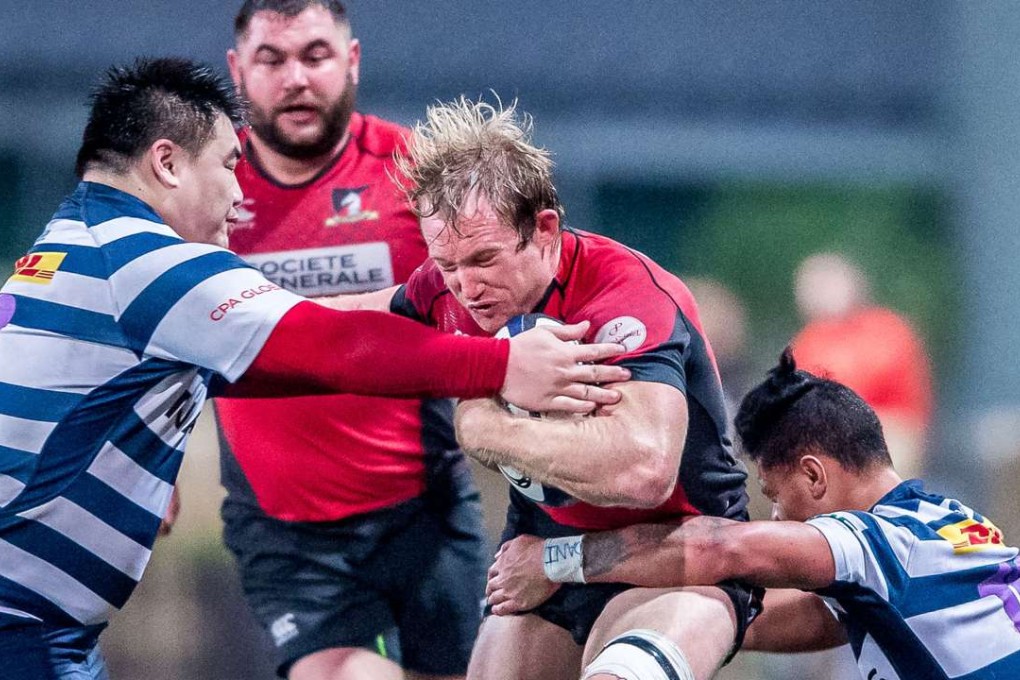 Toby Fenn takes on two HKFC tacklers during Valley’s impressive win in the Hong Kong Premiership on Saturday. Photos: HKRU
