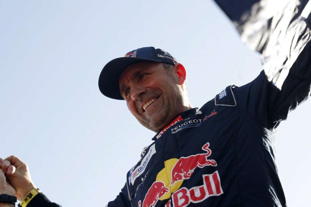 Stephane Peterhansel of Peugeot celebrates his Dakar Rally victory. Photo: EPA