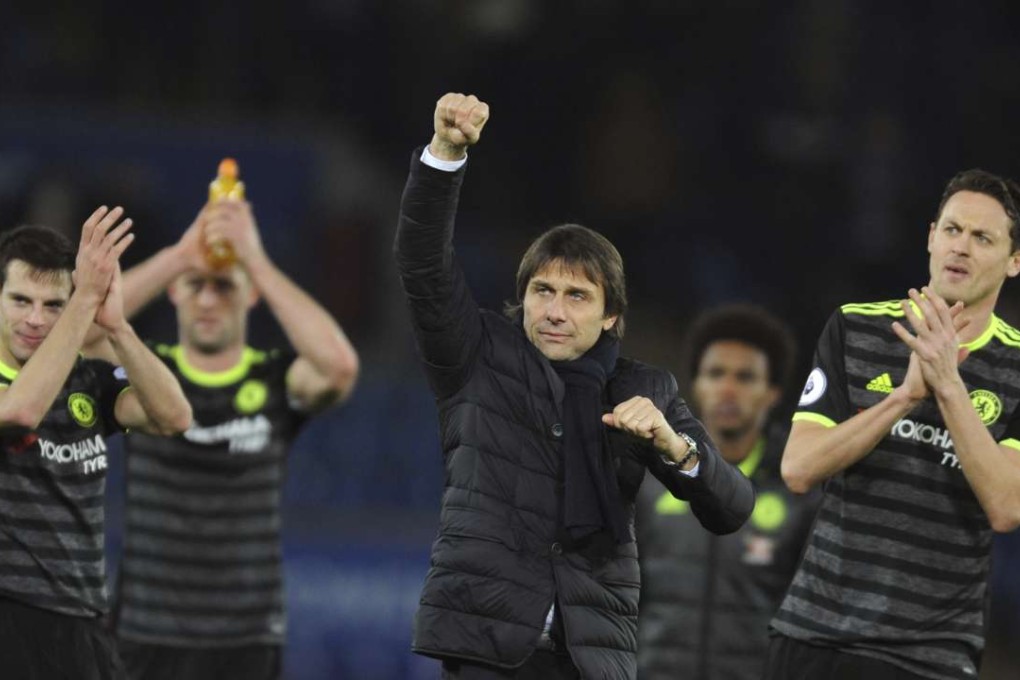 Chelsea manager Antonio Conte, centre, celebrates towards fans after the English Premier League soccer match between Leicester City and Chelsea at the King Power Stadium in Leicester, England, Saturday, Jan. 14, 2017. (AP Photo/Rui Vieira)