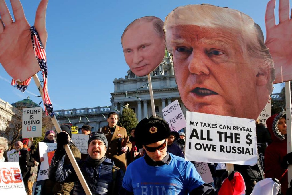 FILE PHOTO: People protest against US President-elect Donald Trump as electors gather to cast their votes for US president at the Pennsylvania State Capitol in Harrisburg, Pennsylvania, US December 19, 2016. REUTERS/Jonathan Ernst/File photo