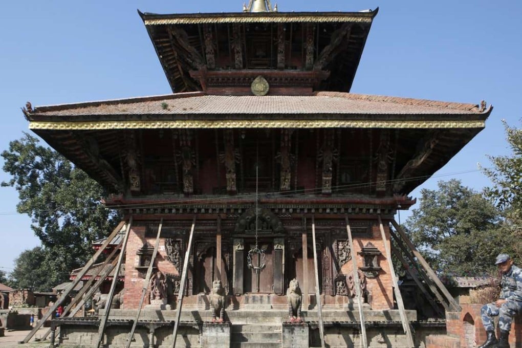 A policeman rests in front of Changu Narayan, a temple dedicated to Lord Vishnu, in Changu Village, Nepal. Photo: AP