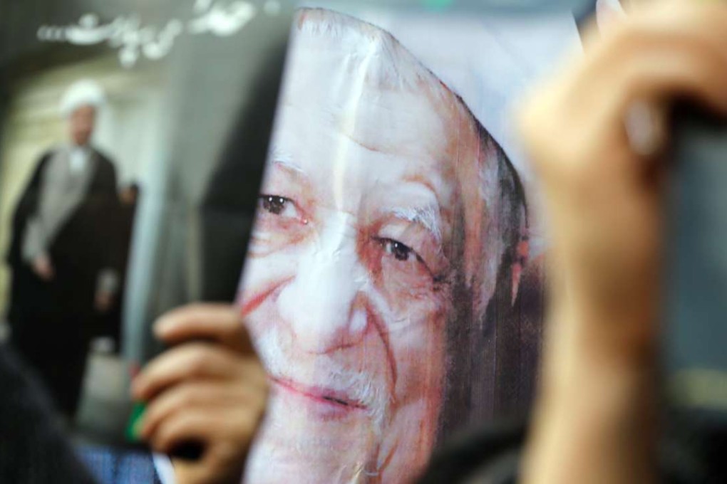 Iranians hold photographs of the late former Iranian President Akbar Hashemi Rafsanjani during his funeral ceremony in Tehran, Iran. Photo: EPA