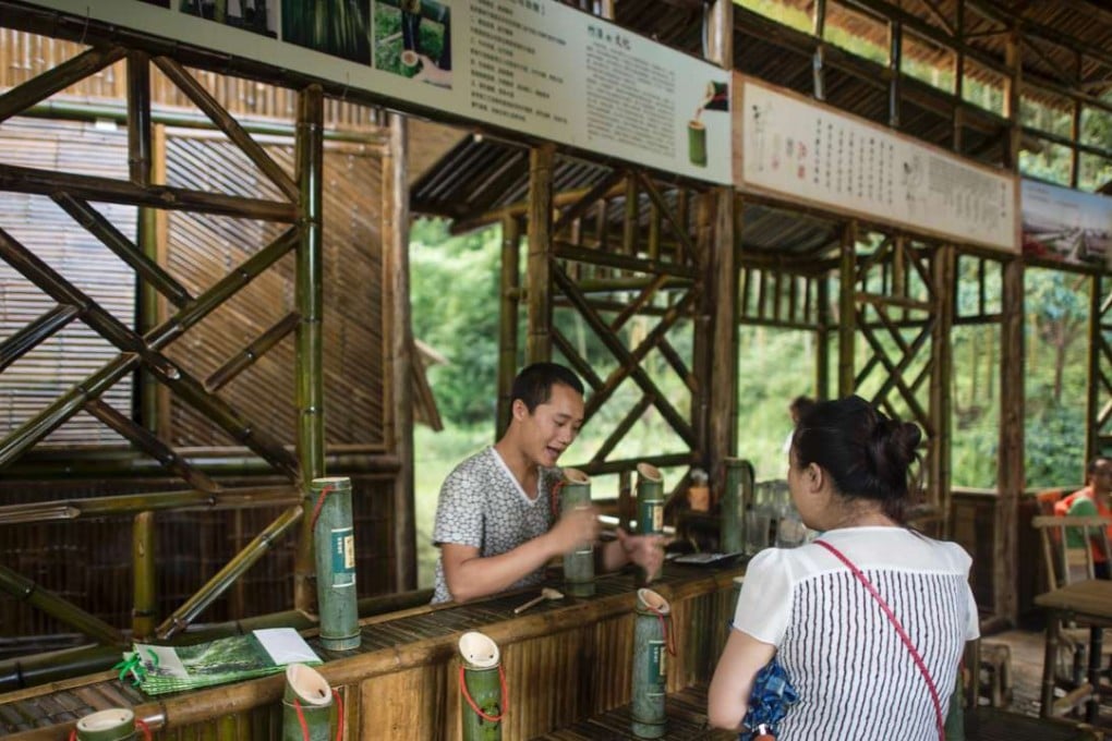 A tourist buys bamboo liqueur in the Yibin bamboo forest. Photo: AFP