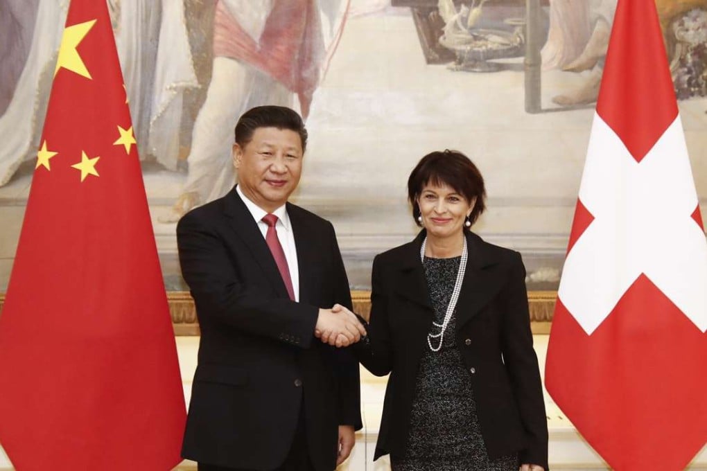 Swiss Federal President Doris Leuthard, right, and President Xi Jinping shake hands before official talks in Bern, Switzerland, on Monday. Photo: AP