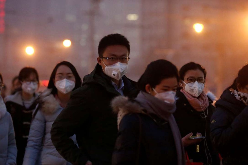 People wear face masks as they cross a street on a polluted day, on January 4, in Beijing. Photo: Reuters