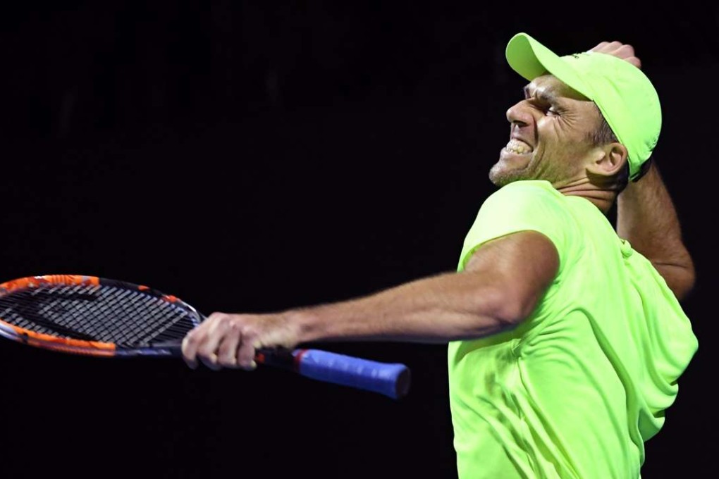 Croatia's Ivo Karlovic celebrates after his marathon victory against Argentina’s Horacio Zeballos in Melbourne. Photo: AFP