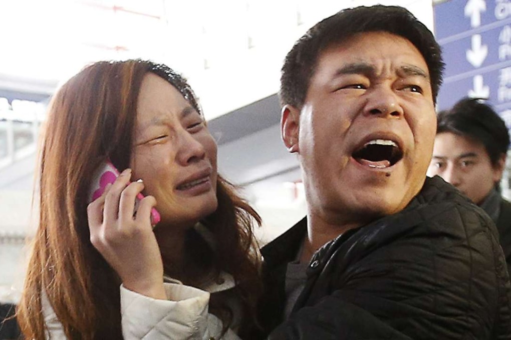 A relative of a passenger onboard Malaysia Airlines flight MH370 cries as she talks on her mobile phone at Beijing Capital International Airport March 8, 2014. File photo: Reuters