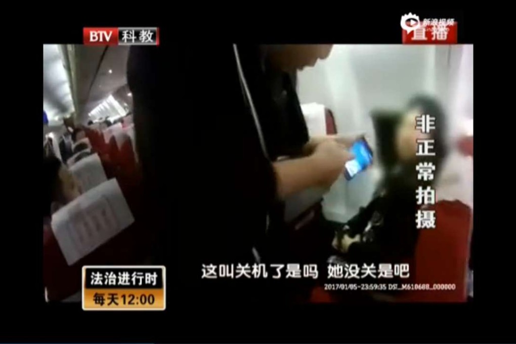 A screen grab of the video showing cabin crew telling the passenger to turn off her mobile. Photo: Sina.com