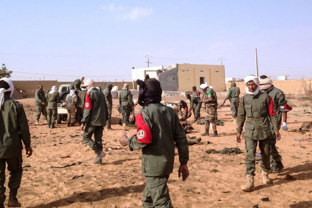 Soldiers attend to wounded and casualties in the aftermath of a suicide bomb attack who ripped through the camp. Photo: AFP