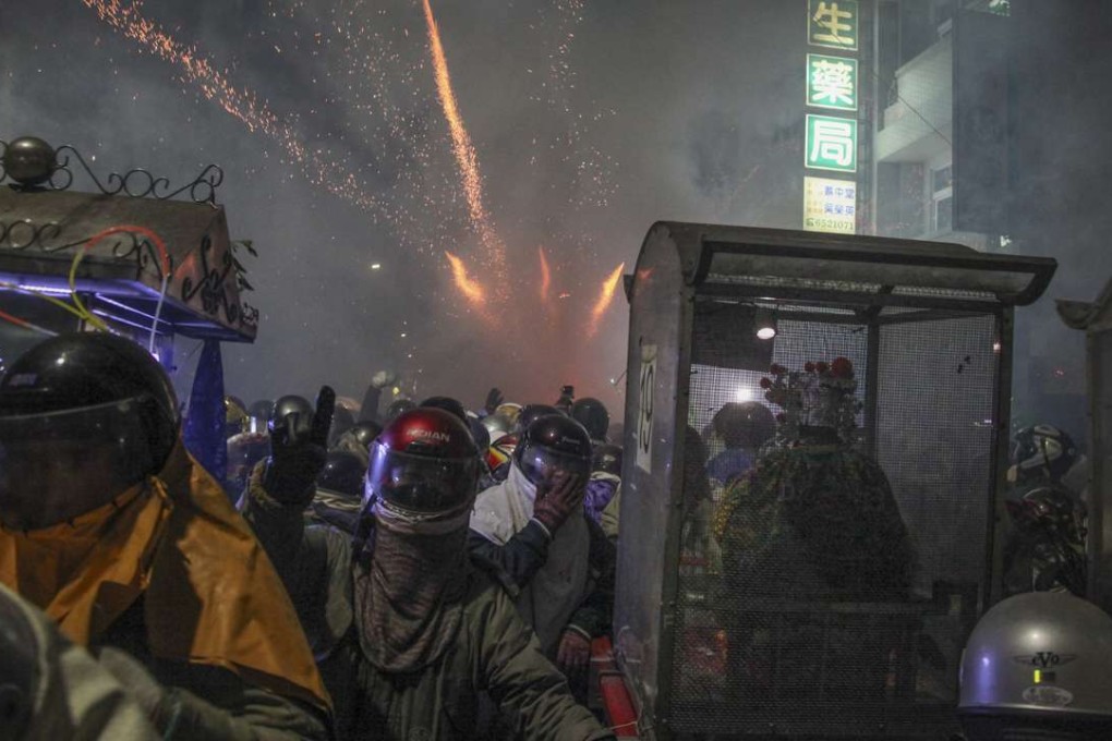 Statues of gods are carried on litters while “beehives” explode in the background. Pictures: Paul Ratje