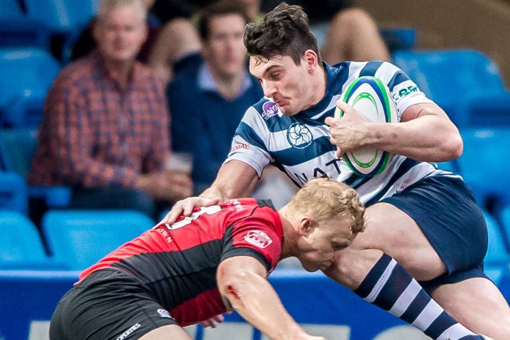 HKFC’s Charlie Higson-Smith is tackled by Max Woodward in the Hong Kong Premiership on Saturday. Photo: HKRU