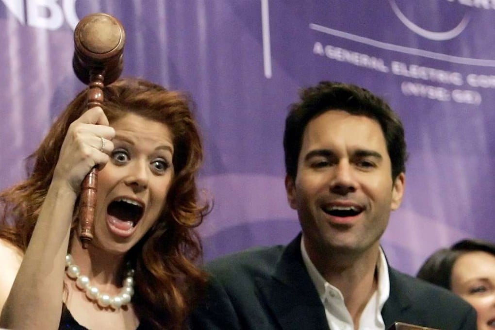 Members of the cast of the NBC television series "Will and Grace" Debra Messing (L) Eric McCormack (C) and Megan Mullally (R) clown around on the bell balcony overlooking the main trading floor of the New York Stock Exchange shortly before ringing the closing bell for the session in New York on May 18, 2006. Photo: Reuters