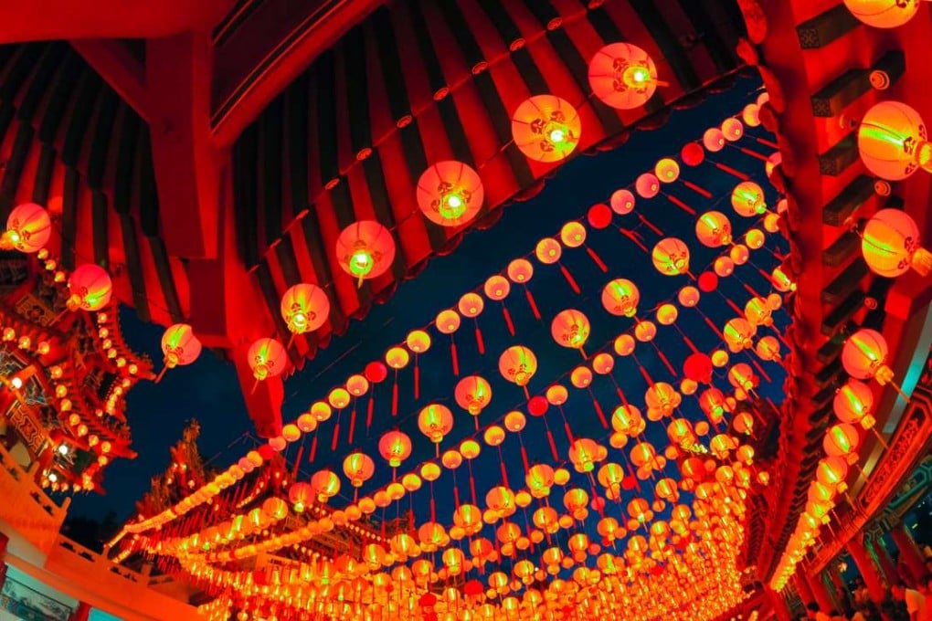 Red lanterns light up the Penang Snake Temple, Malaysia, at Lunar New Year.