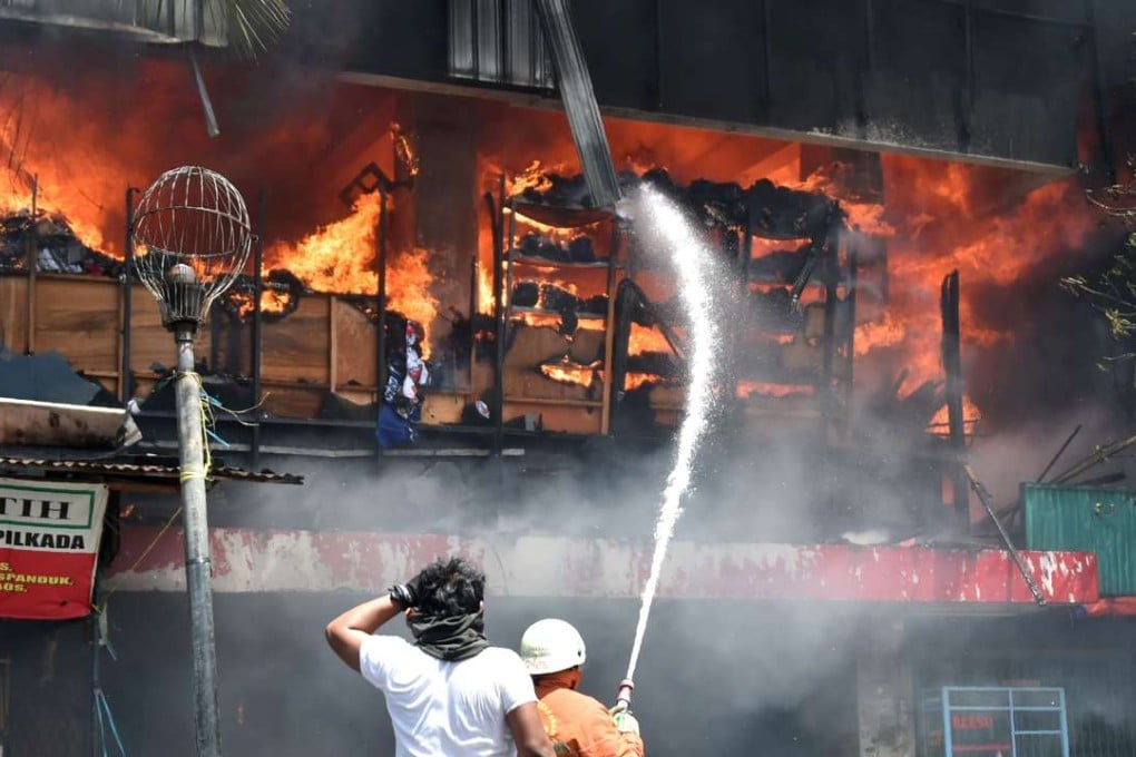 Firefighters battle a massive blaze at one of the biggest shopping centres in Jakarta. Photo: AFP