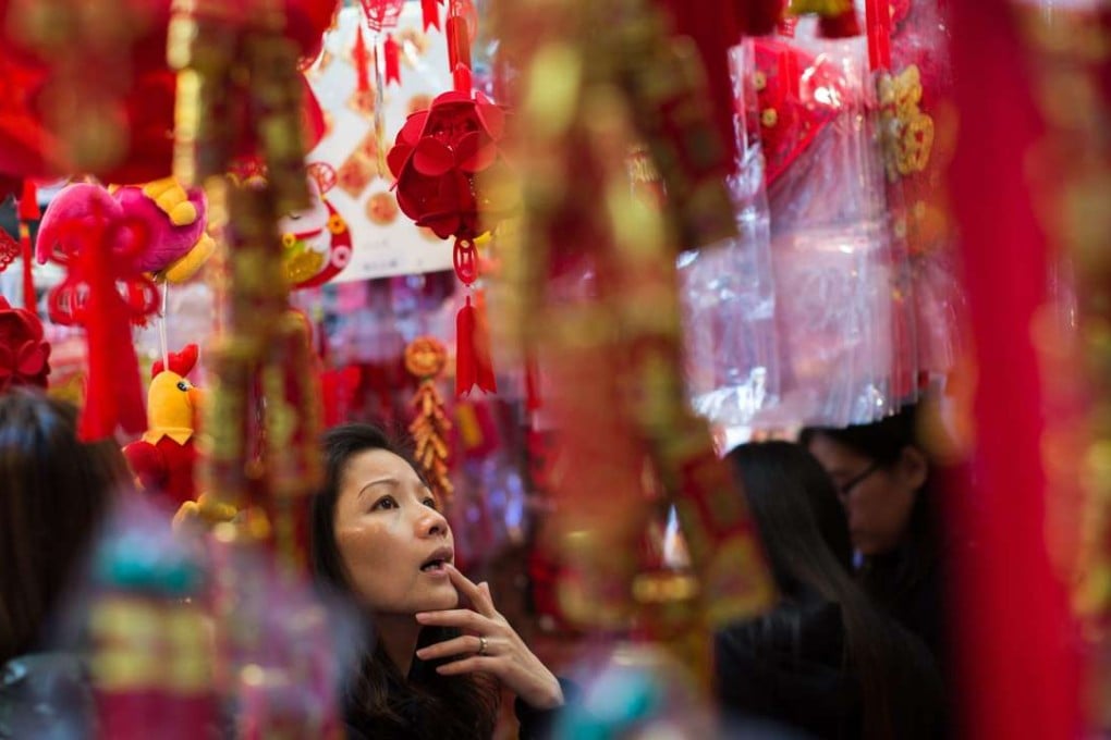 Hong Kong people prepare to celebrate the Lunar New Year. With US interest rates heading upwards, and mainland China rebalancing, the IMF expects only a gradual pick-up in Hong Kong’s growth rate, to 1.9 per cent in 2017. Photo: EPA