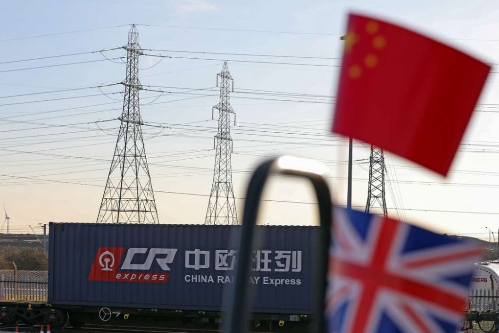 A Chinese national flag, top, and a Union flag, also known as the Union Jack, sit next to each other against a backdrop of the first freight train to travel from China to Britain at the DB Cargo AG London Eurohub depot in Barking. Photo: Bloomberg