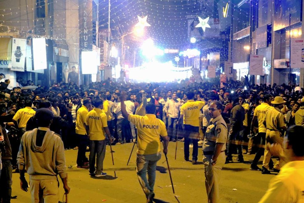 Indian police struggle to manage the crowds during New Year’s Eve celebrations in Bangalore. Photo: AFP
