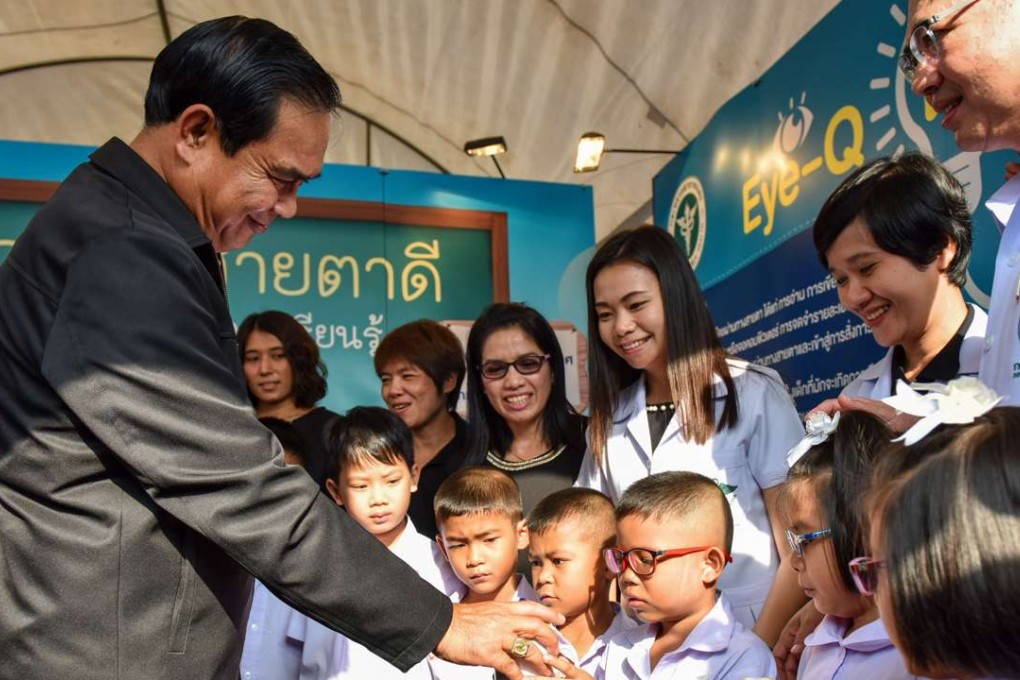 Thai Prime Minister Prayuth Chan-ocha gives presents to kids during a Children's Day celebration at the Sanam Suea Pa Park in Bangkok. Photo: Xinhua