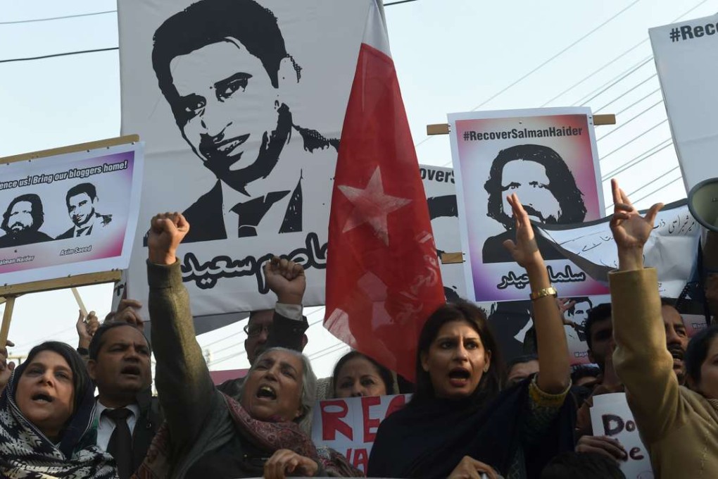 Pakistani rights activists hold images of bloggers who have disappeared, during a protest in Lahore on January 12. Photo: AFP