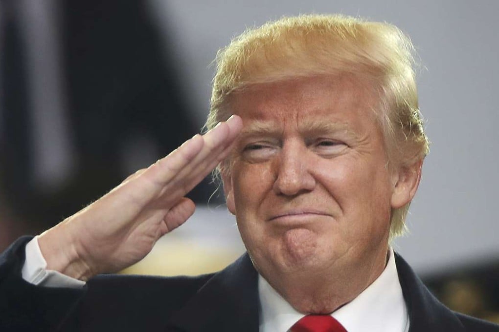 US President Donald Trump salutes participants during the inaugural parade in Washington on Friday. Photo: Reuters