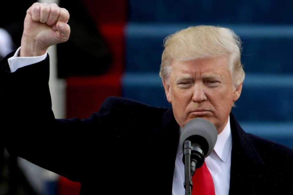 US President Donald Trump raises a fist after his inauguration on Friday. Photo: AFP