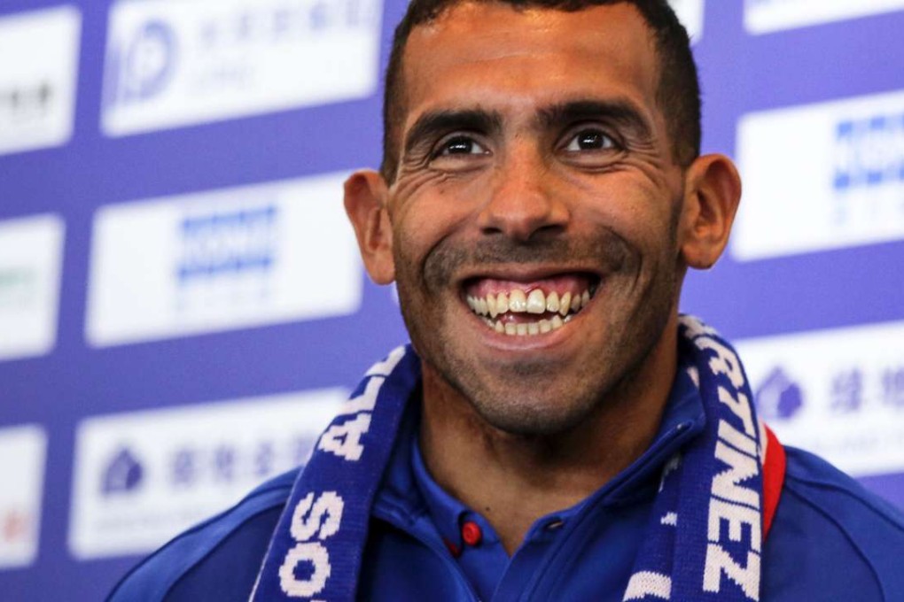 Argentine striker Carlos Tevez smiles during a press conference in Shanghai on January 21, 2017. Photo: AFP