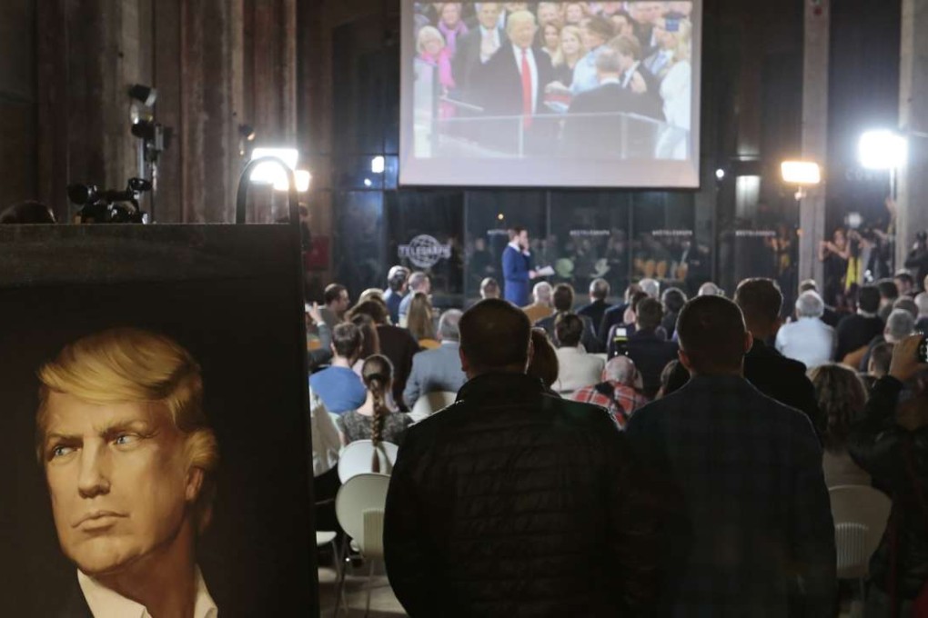 Russians watch the inauguration ceremony for Donald Trump at a party in Moscow. Photo: AP