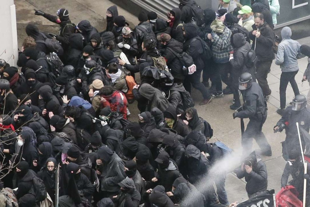 Police use pepper spray on protesters in Washington, Friday, Jan. 20, 2017, in a chaotic confrontation blocks from Donald Trump's inauguration. Photo: AP