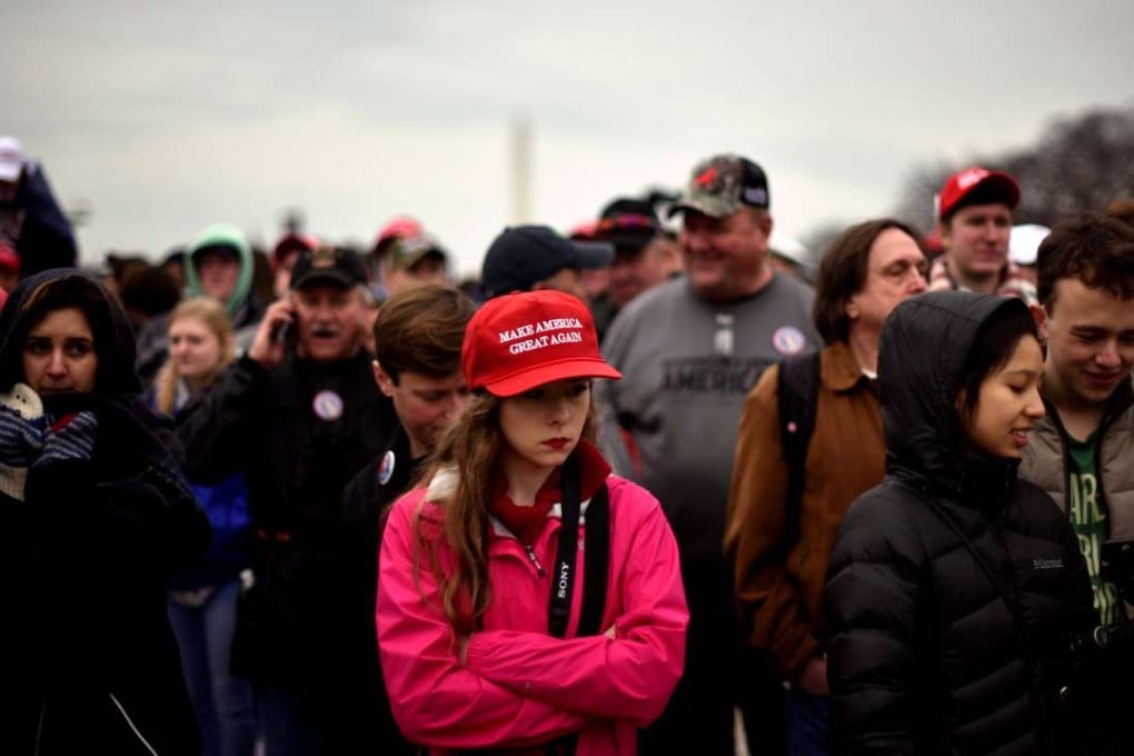 The crowd on the National Mall reacts during the inauguration of US President Donald Trump in Washington on Friday. Photo: Reuters