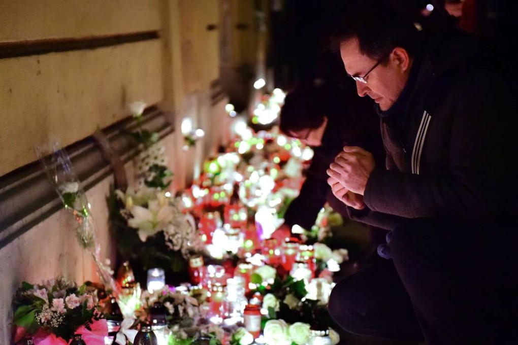 Candles and flowers are placed at the Szinyei Merse Pal High-school in Budapest, to commemorate the victims of a bus accident in Italy. Photo: AFP