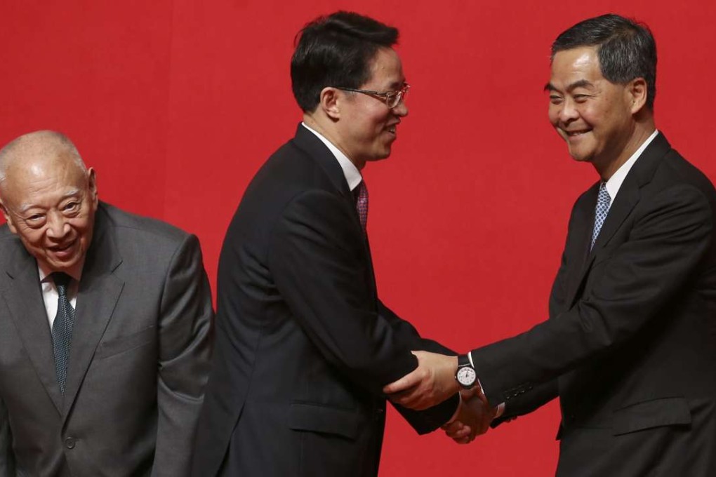 Leung Chun-ying shakes hands with Zhang Xiaoming, director of the central government’s liaison office in Hong Kong, at a reception on Thursday, while former chief executive Tung Chee-hwa looks on. Leung’s last address was curiously bloodless. It was as though he felt that he had been let down by those whom he had most tried to please. Photo: Sam Tsang
