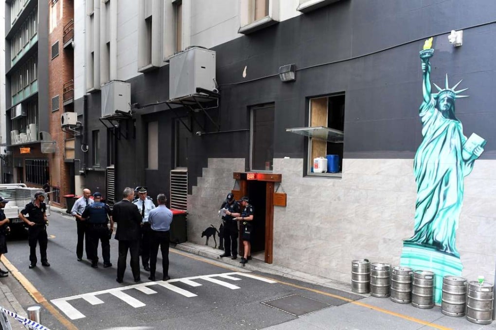Police officers are seen at a cordoned off area after a man was accidentally shot in Eagle Lane in Brisbane's central business district, Queensland, Australia. Photo: EPA