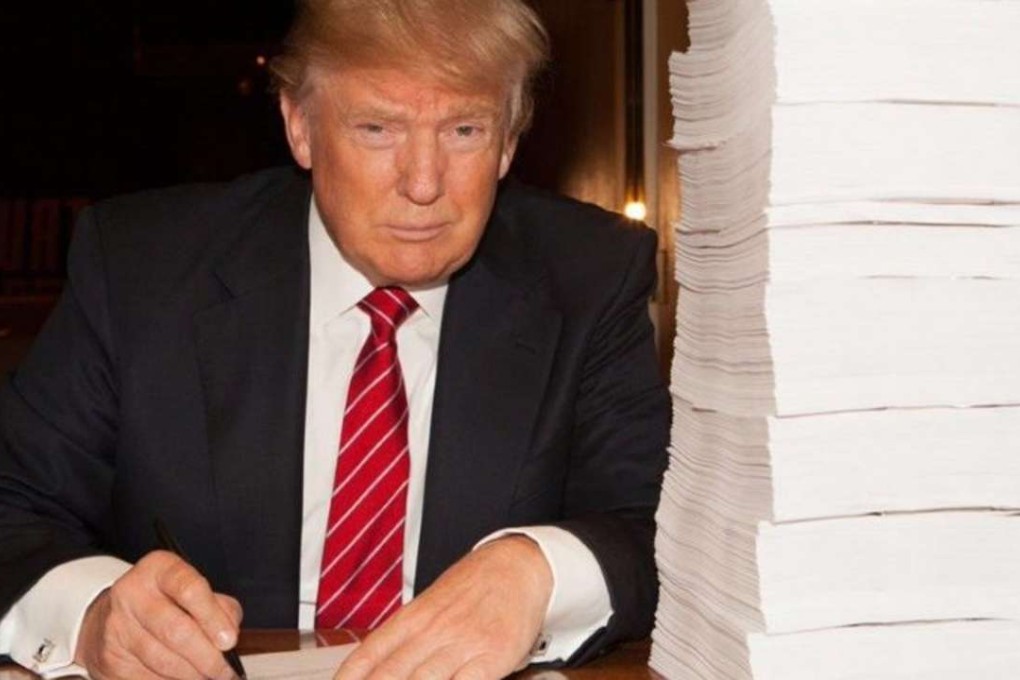 Donald Trump purporting to sign a recent tax return in an image he shared on Twitter last year. Photo: Twitter / @RealDonaldTrump
