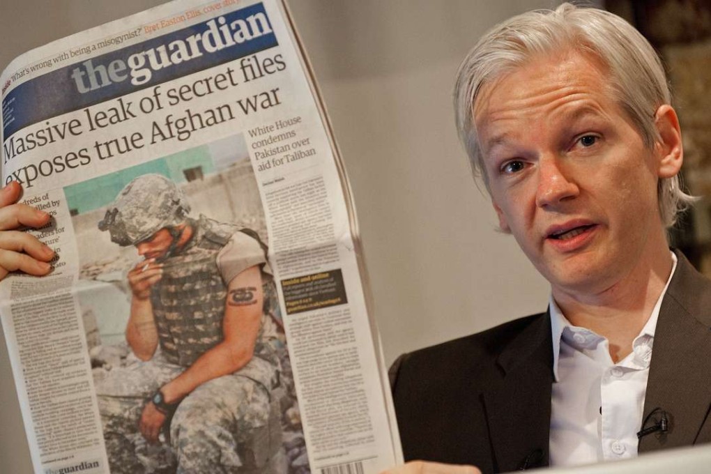 Australian founder of whistle-blowing website, WikiLeaks, Julian Assange, holds up a copy of The Guardian newspaper during a press conference in London on July 26, 2010. Photo: AFP