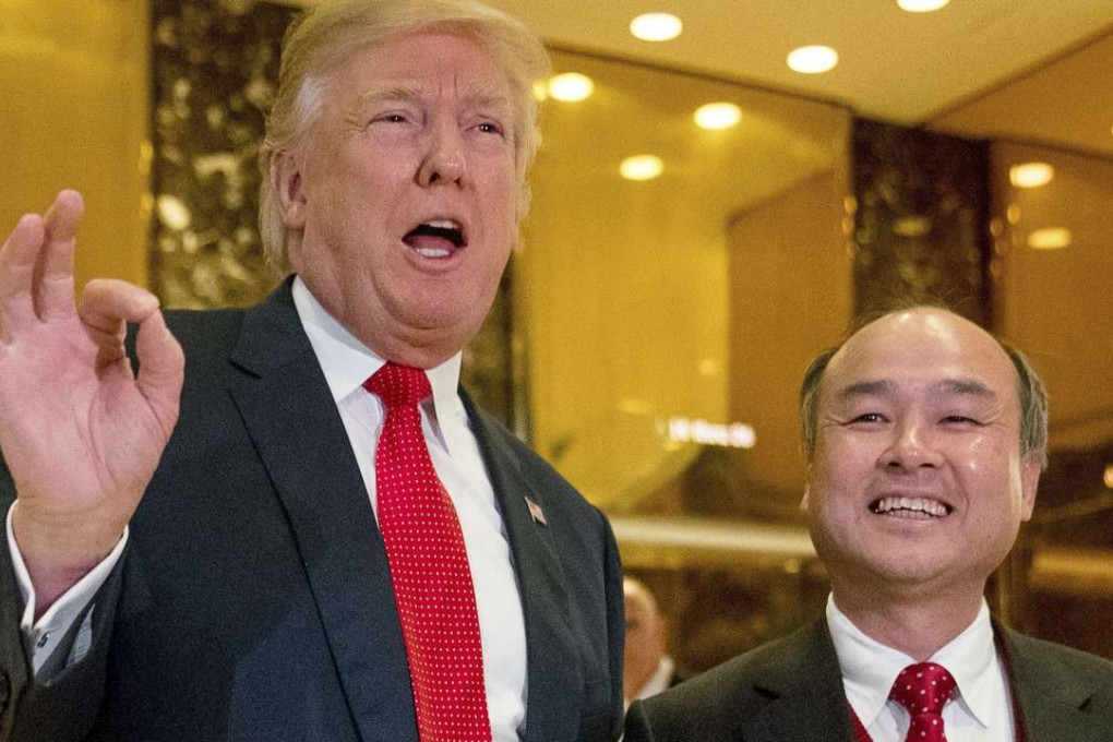 Then USPresident-elect Donald Trump, left, accompanied by SoftBank CEO Masayoshi Son, speaks to members of the media on the creation of 8,000 new US jobs by the Japanese tech mogul. Photo: AP