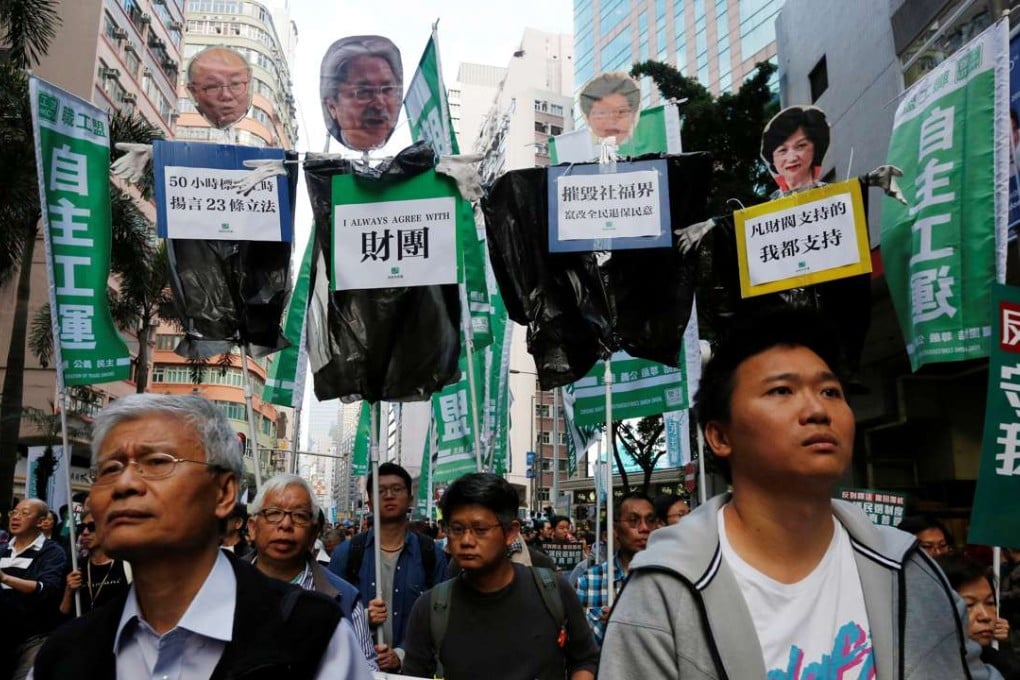 Protesters carry effigies of declared and then-potential chief executive candidates (from left) Woo Kwok-hing, John Tsang, Carrie Lam and Regina Ip, during a pro-democracy march in Hong Kong on January 1. Photo: Reuters