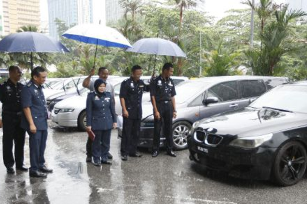 Dang Wangi police chief Assistant Commissioner Mohd Sukri Kaman and Zaida Hussin, RTD's Kuala Lumpur enforcement division with the seized clone cars. Photo: Supian Ahmad/NST