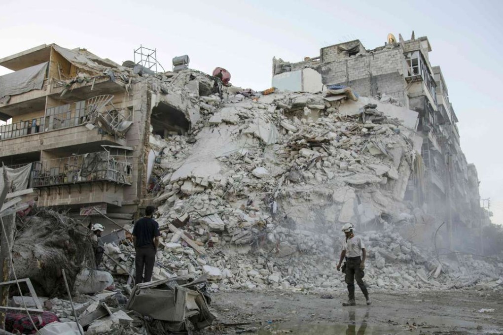 This file photo taken on October 17, 2016 shows members of the Syrian Civil Defence, known as the White Helmets, searching for victims amid the rubble of a destroyed building following reported air strikes in the rebel-held Qatarji neighbourhood of the northern city of Aleppo. Photo: AFP