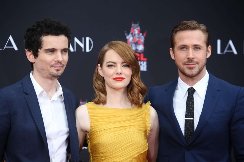 Emma Stone and Ryan Gosling, stars of La La Land, pose with its director Damien Chazelle. The musical secured a record-equalling 14 Oscar nominations. Photo: EPA