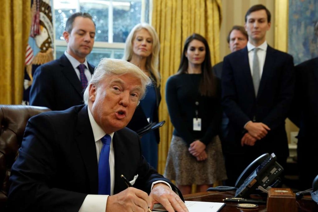 President Donald Trump shows his signature on an executive order on the Keystone XL pipeline, Tuesday, Jan. 24, 2017. Photo: Reuters