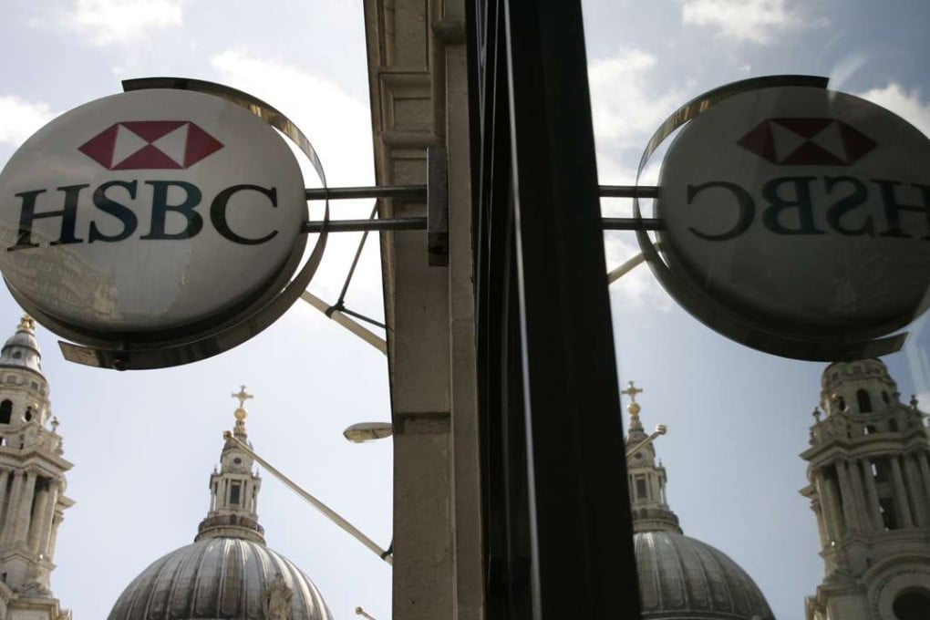 The sign for a branch of HSBC, backdropped by part of St. Paul's Cathedral in central London. Photo: AP