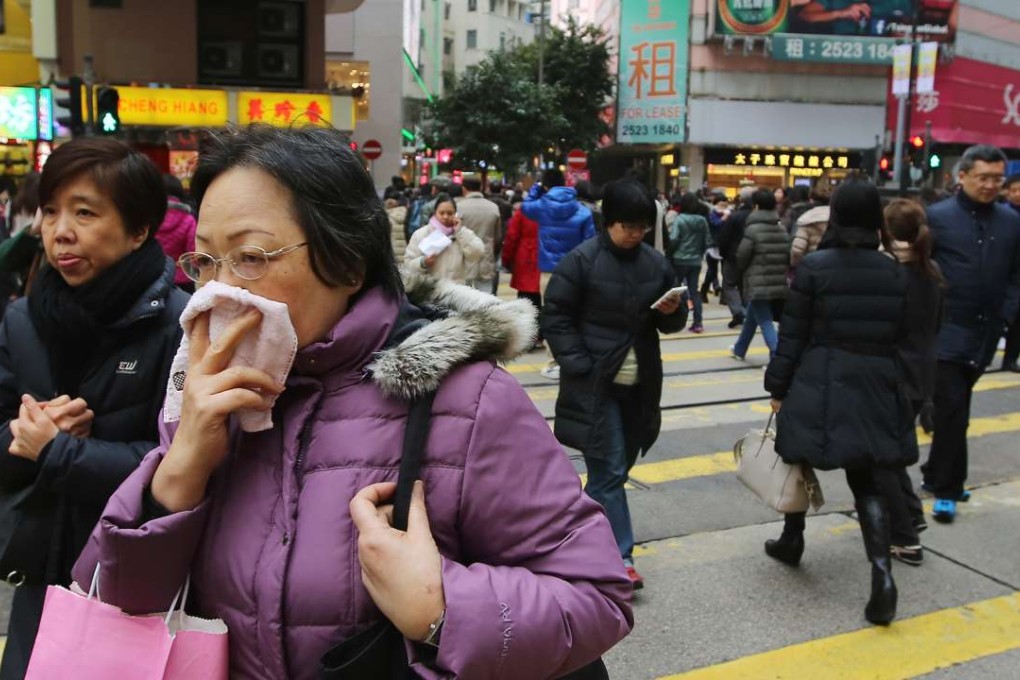 A woman covering her mouth in Causeway Bay. Photo: Sam Tsang