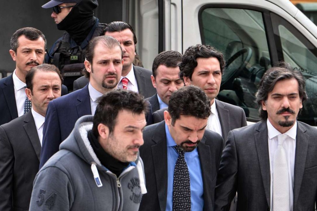 The eight Turkish army officers are escorted by Greek police as they arrive at court. Photo: AFP